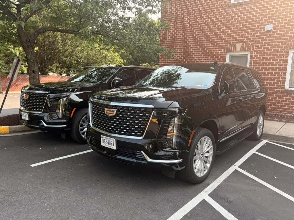 Black Cadillac Escalade parked at dusk